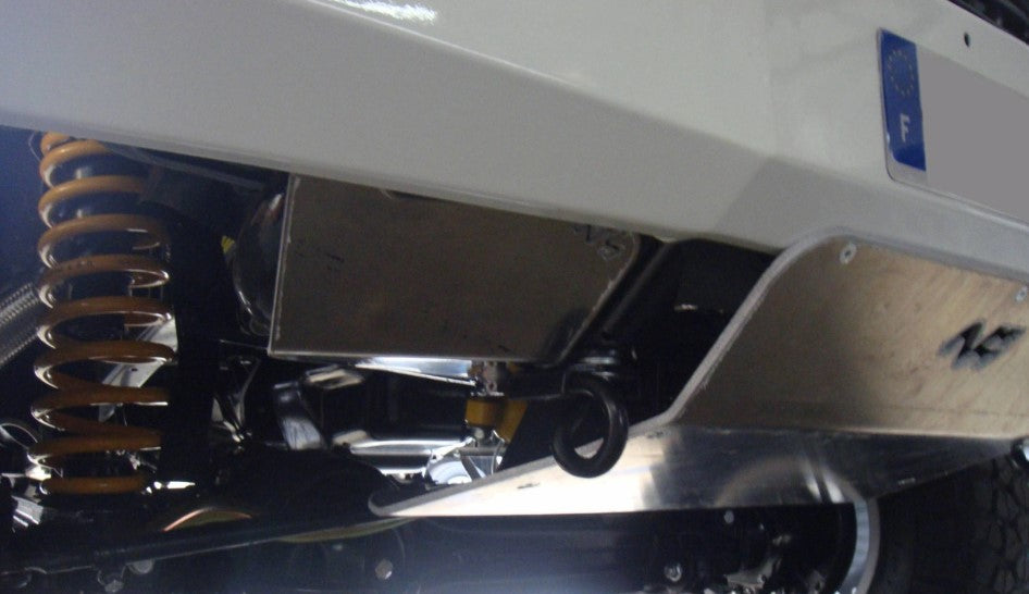 Protección vista desde debajo de un vehículo con un y un muelle amarillo