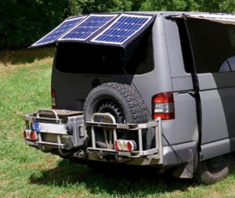 vista trasera de un transportador de hierba con portarruedas trasero y panel solar